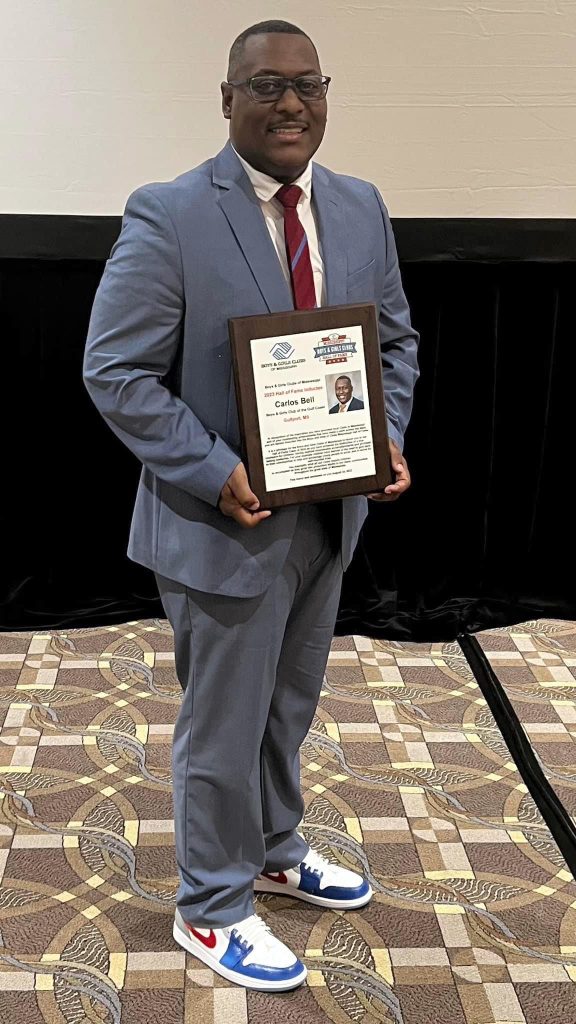 Carlos Bell holds his Mississippi Boys & Girls Clubs Hall of Fame award