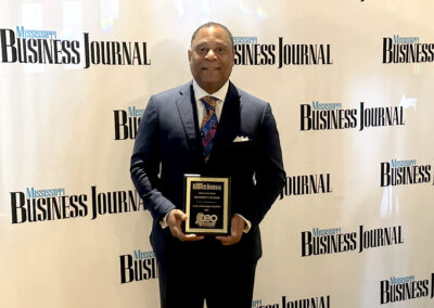 Matthew T. Butler poses with his Mississippi Business Journal Top CEO award after the June 13, 2024 breakfast meeting