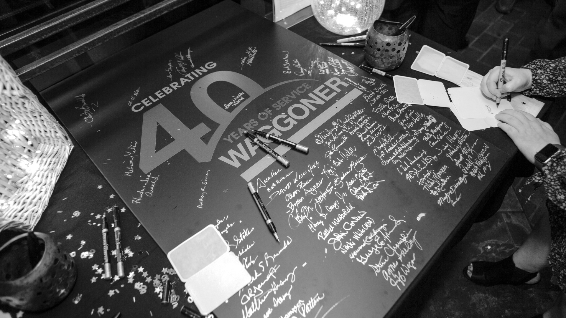 Waggoner - 40 Years of Service in 2016 Alt text: Close-up of a commemorative board reading “Celebrating 40 Years of Service Waggoner,” covered with signatures at a 2016 anniversary event.