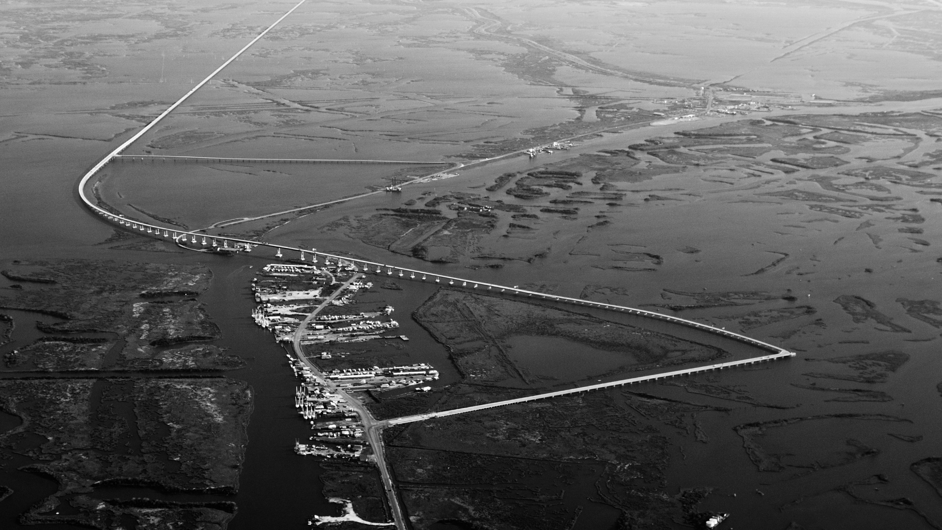 Waggoner - Coastal Highway LA 1 Mega Project Aerial view of the Coastal Highway LA 1 bridge spanning wetlands and open water.