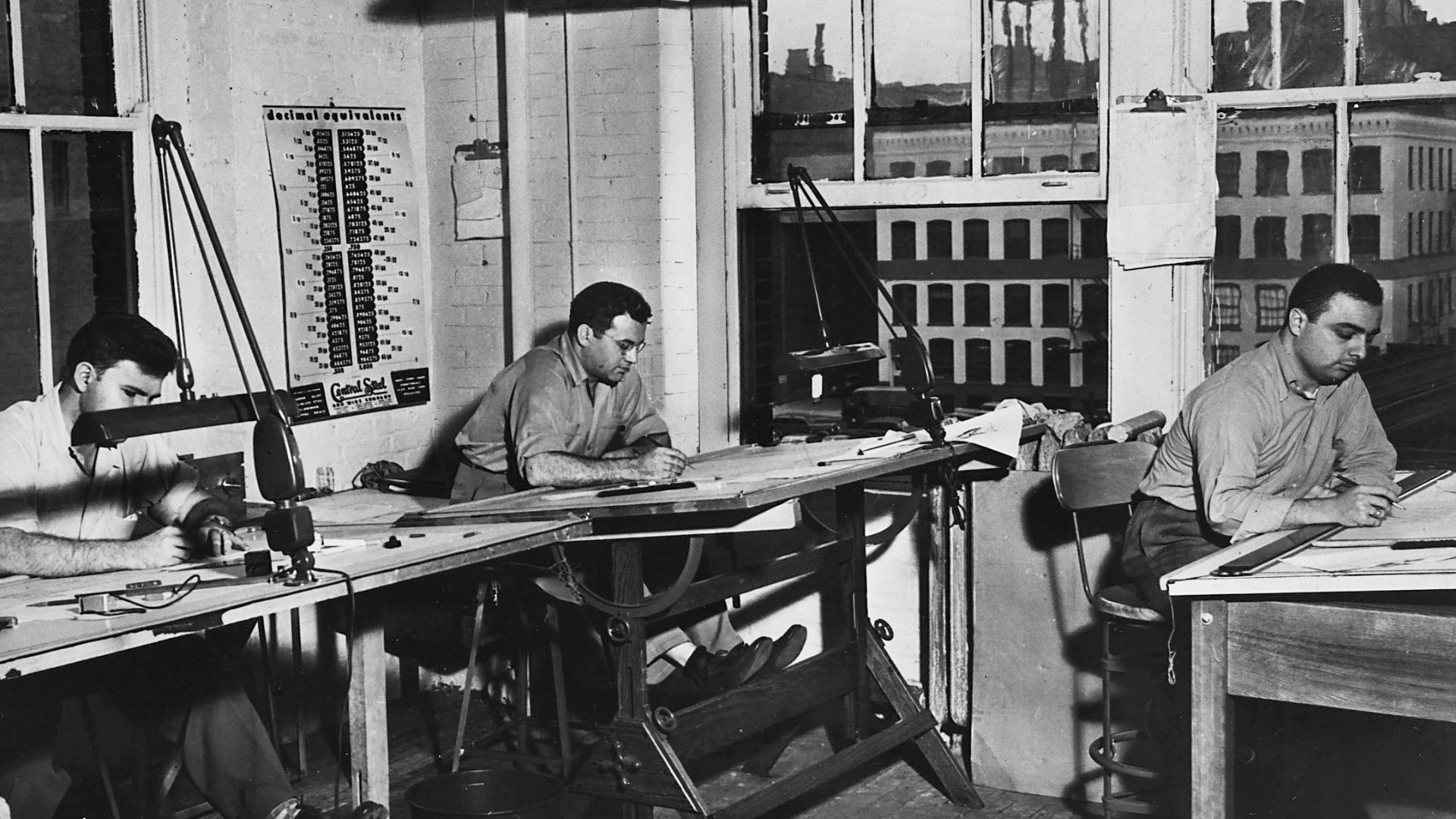 Waggoner - Early Days Black-and-white photo of engineers working at drafting tables during the early days of Waggoner Engineering.