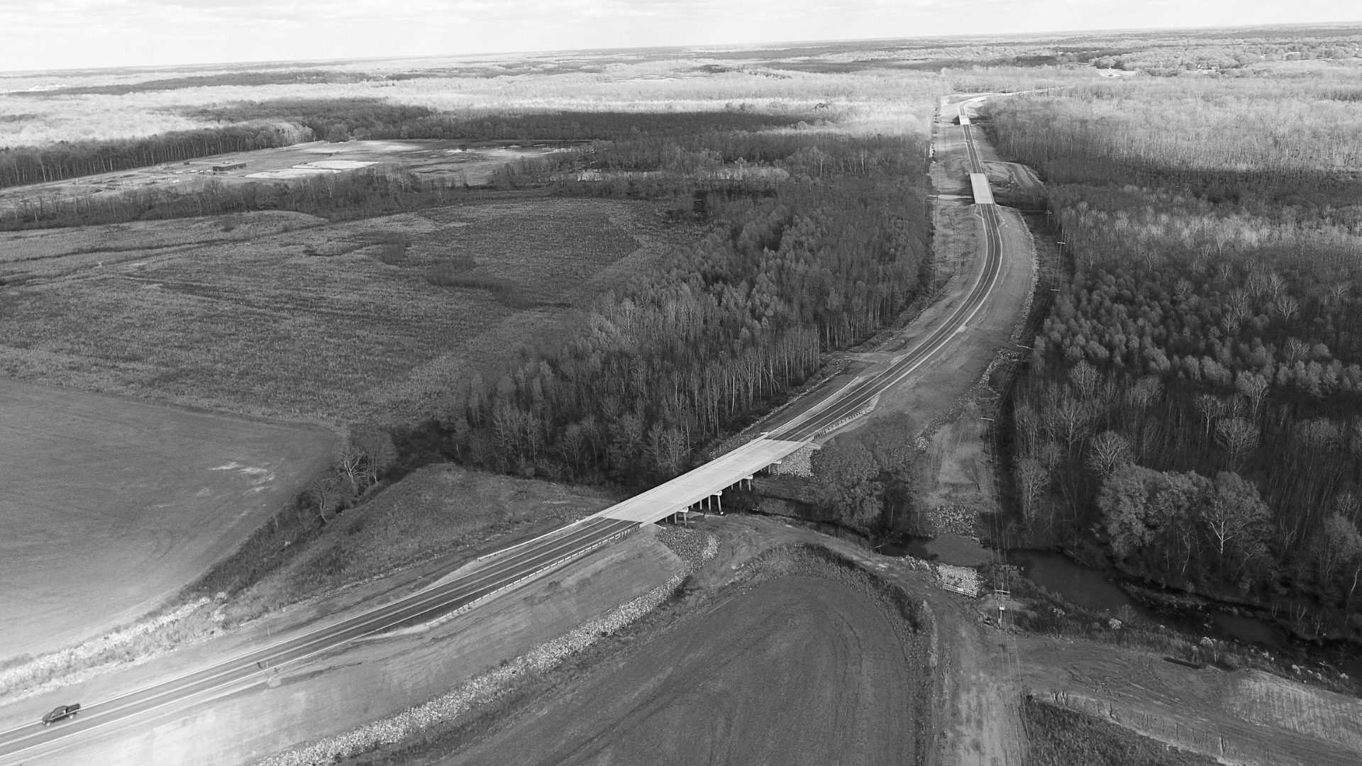 Waggoner - Holly Springs Road Completed View Aerial view of Holly Springs Road with a bridge.
