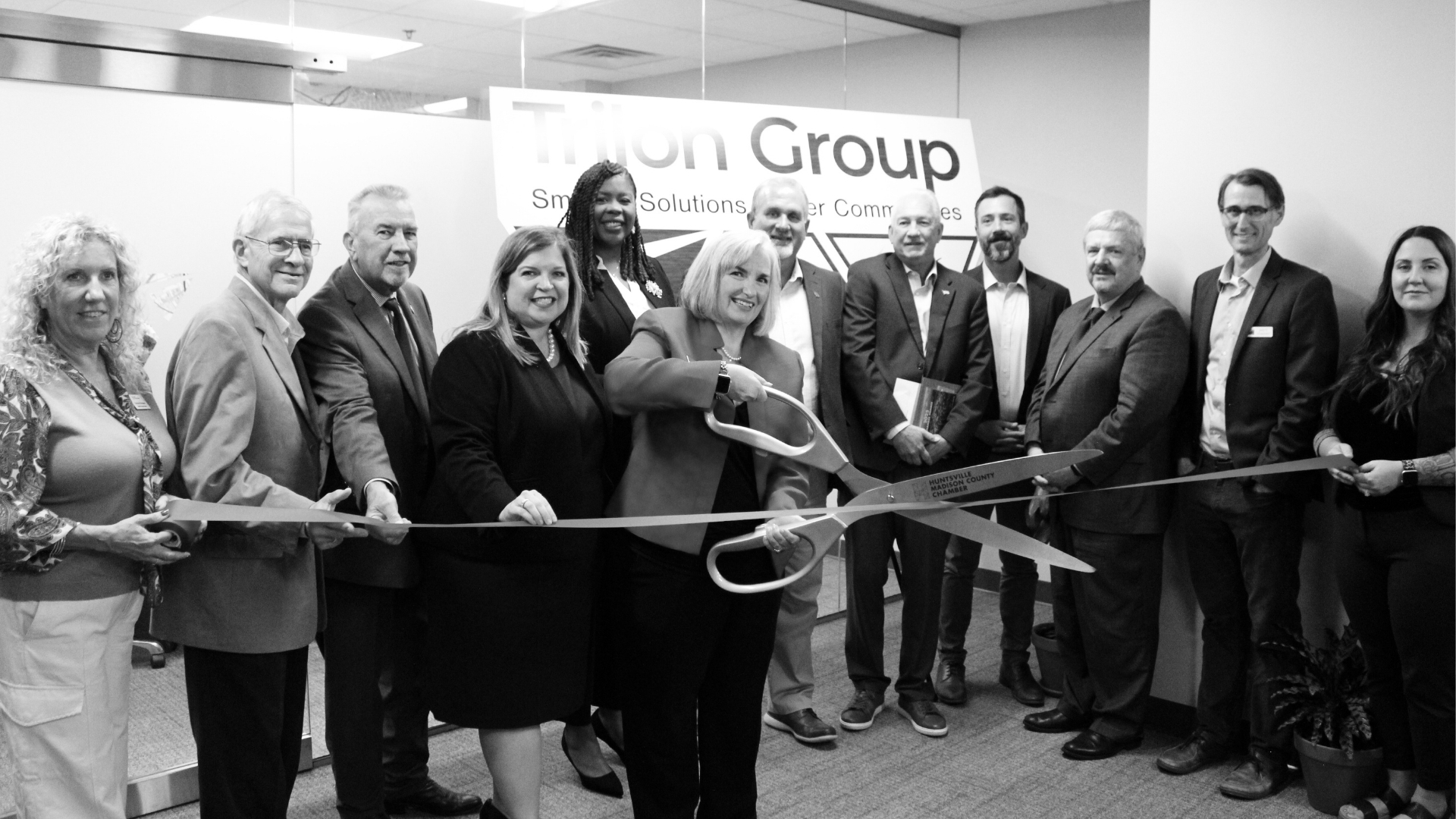Waggoner - Huntsville Office Opening Group of officials and staff cut a ribbon at the Huntsville, Alabama Trilon partners office opening ceremony.