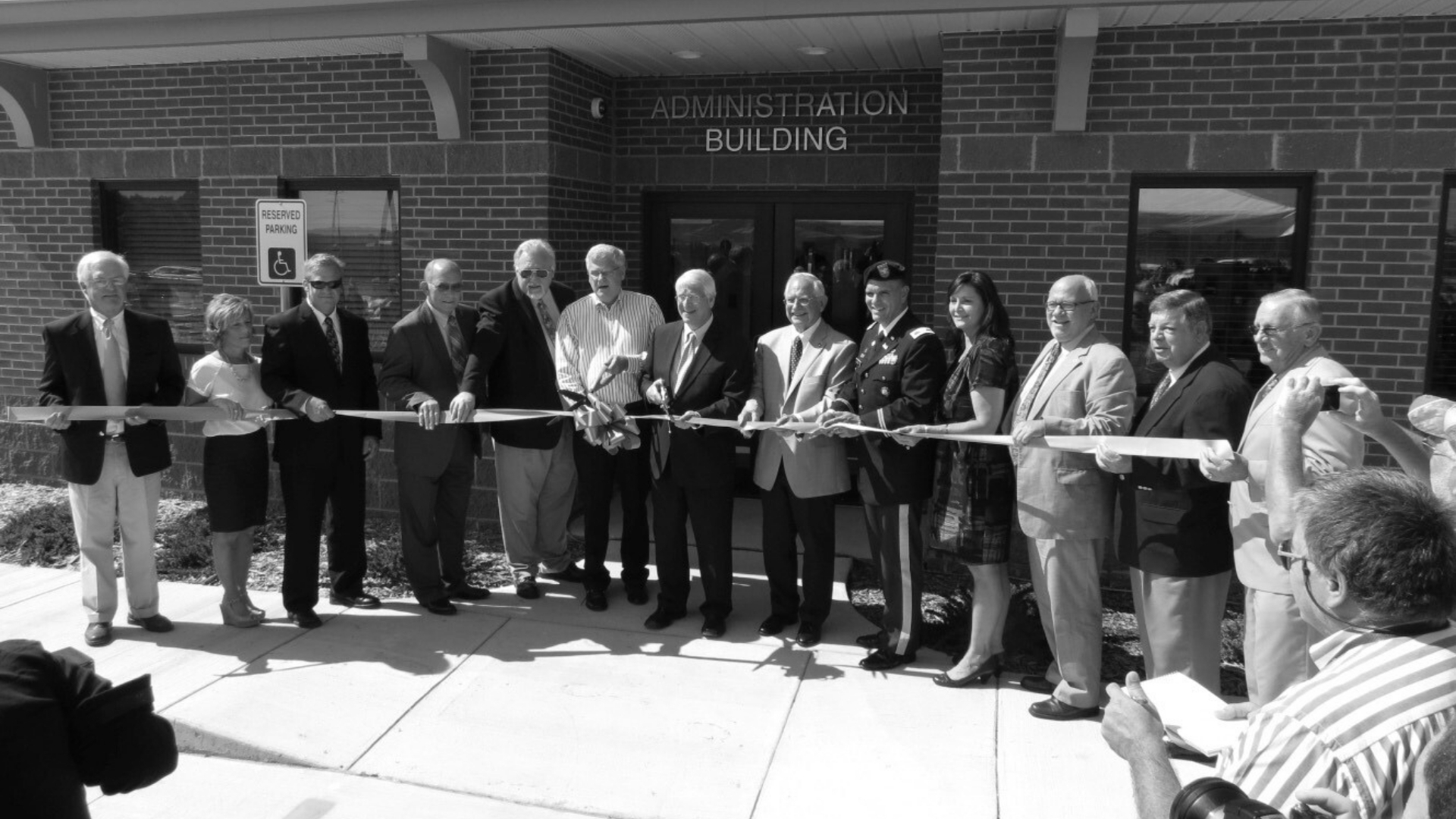 Waggoner - Johnson Creek WWTF Exterior view of the Johnson Creek wastewater treatment facility administration building during a ribbon cutting ceremony.